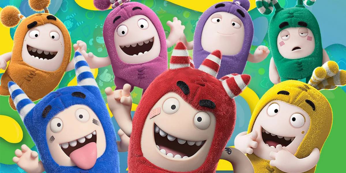 A group of cheerful cartoon characters in fuzzy, colorful costumes—red, blue, yellow, green, and purple—smiling and posing with their arms up against a bright, playful background.